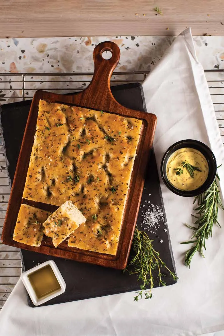 Herb focaccia on a wooden board